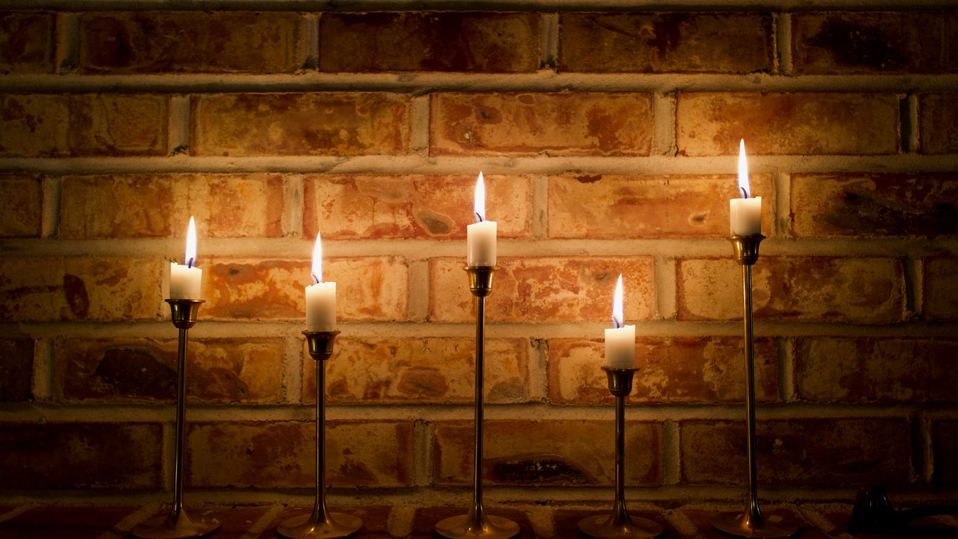 a group of lit candles sitting on top of a table