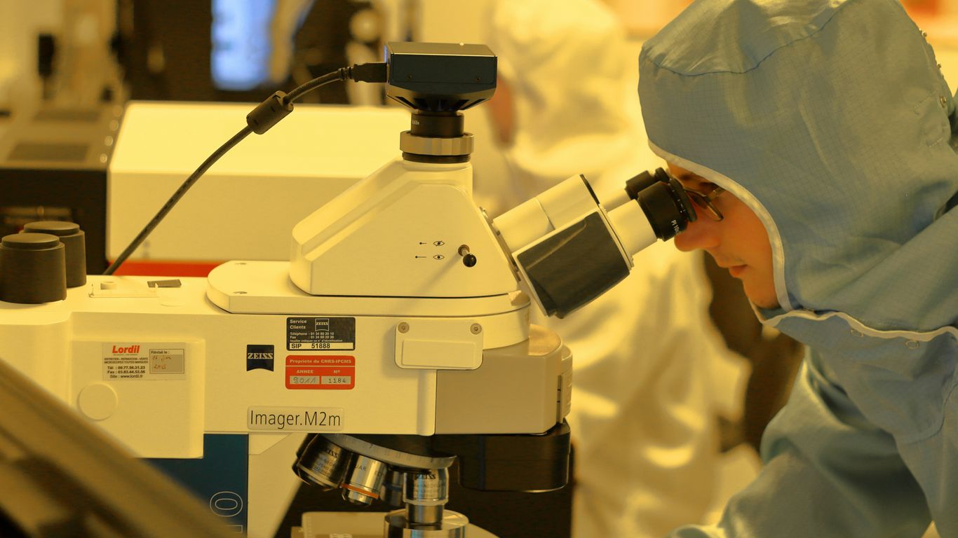 man using microscope