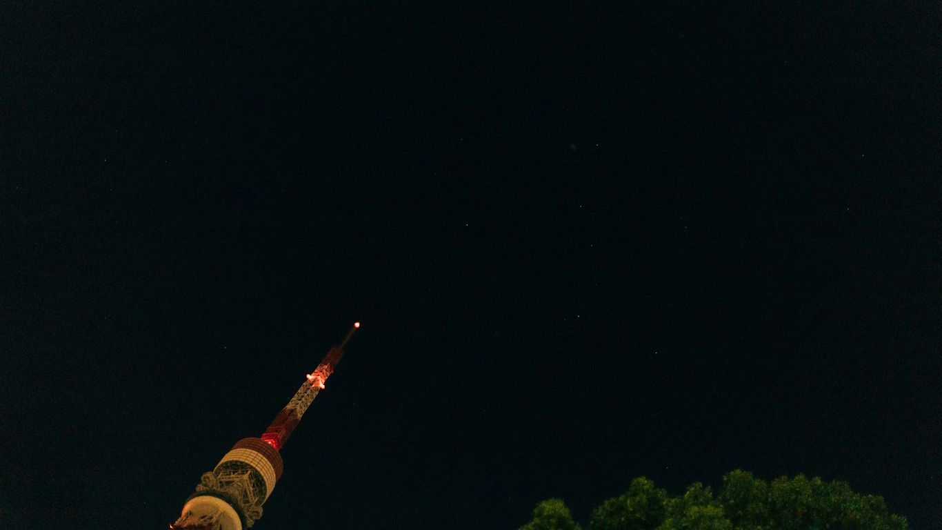 A very tall tower with a clock on it's side
