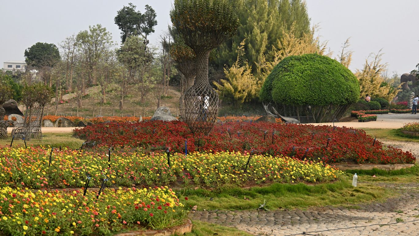 A beautifully manicured garden with colorful flowers and trees.
