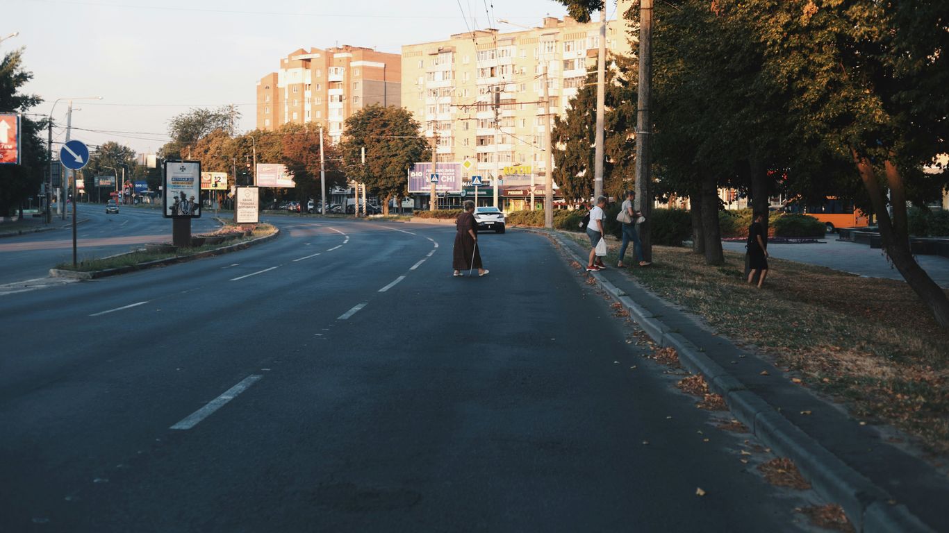 A person riding a skateboard down a street