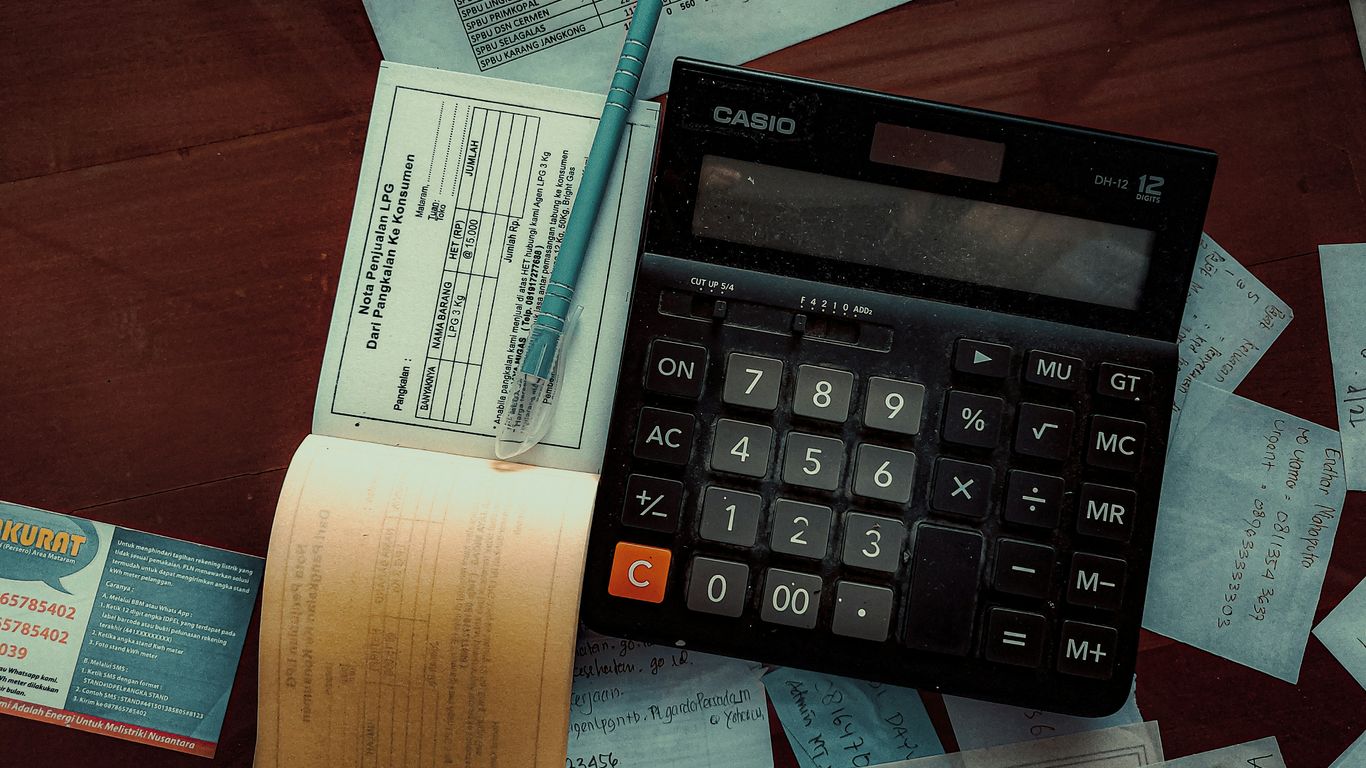 a calculator sitting on top of a wooden table