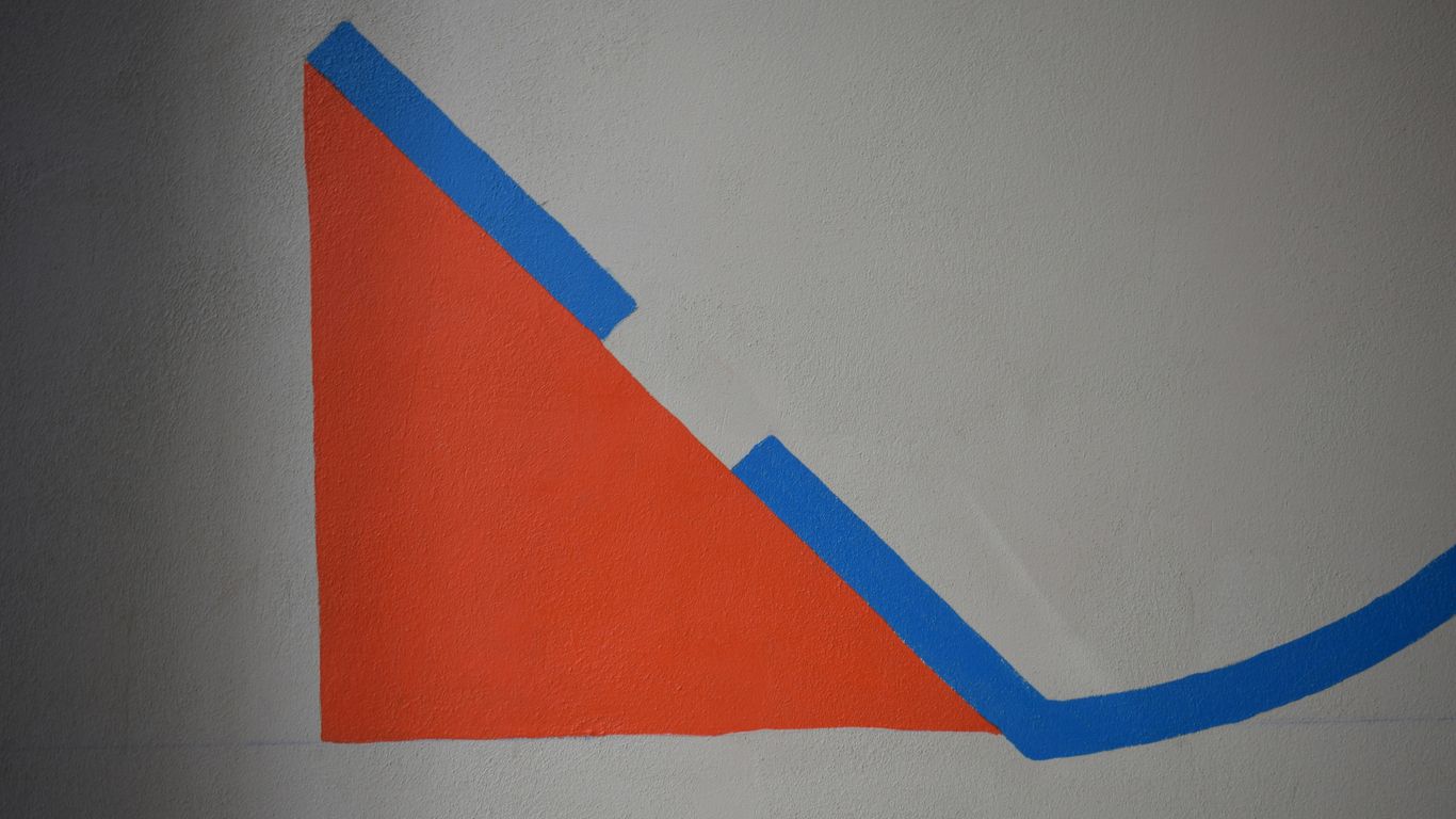 a drawing of a triangle on a white wall