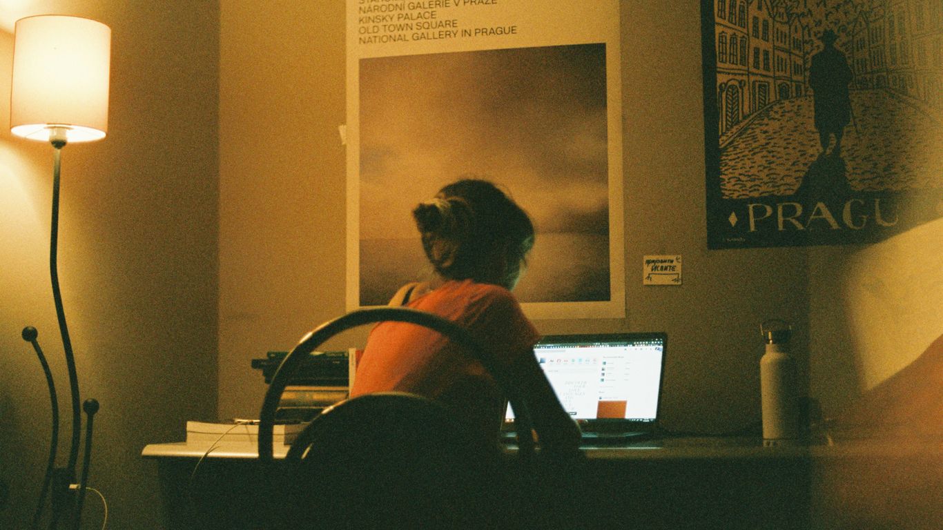 woman in red and black stripe shirt sitting on chair