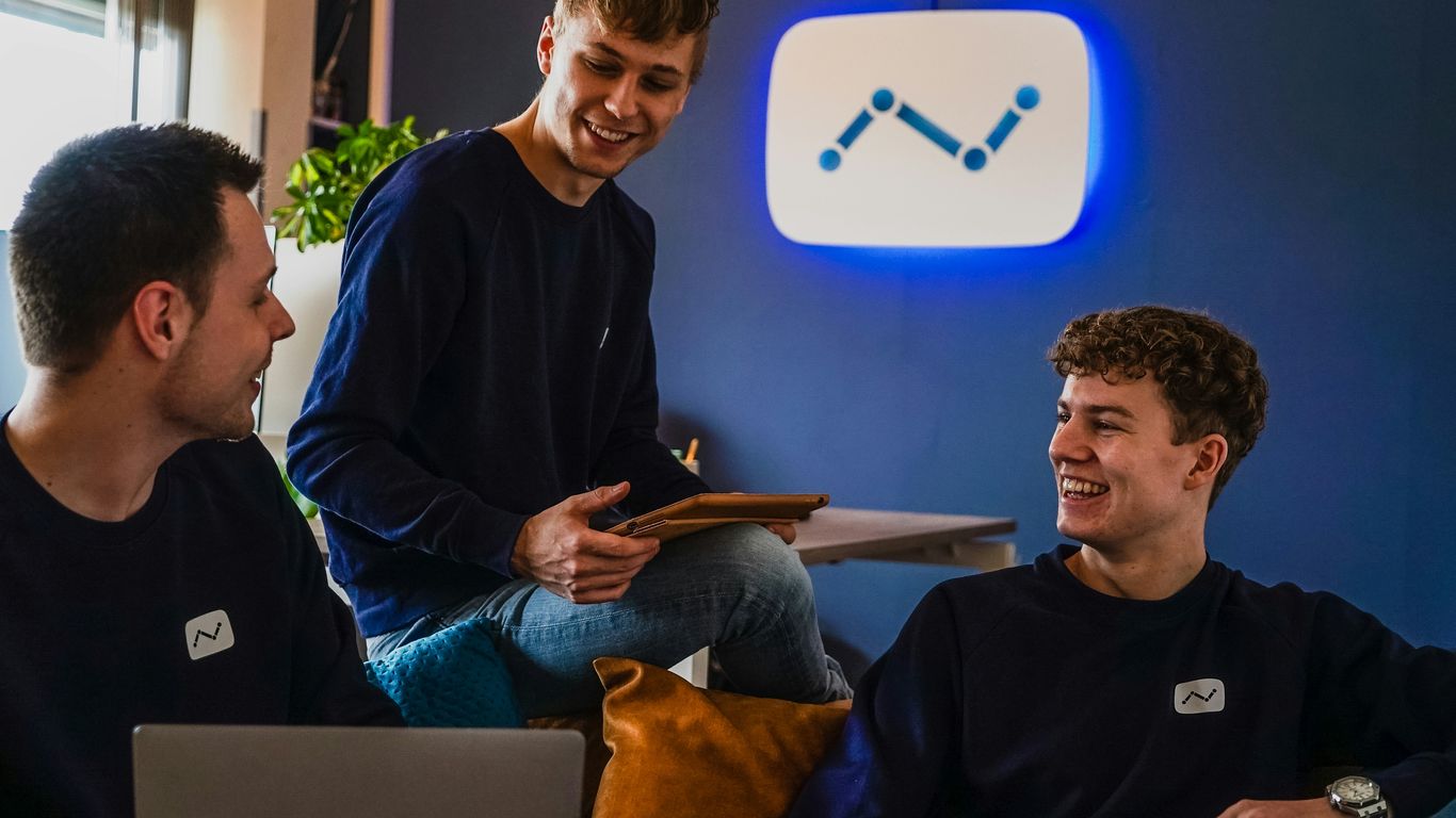 man in black sweater sitting beside man in black sweater