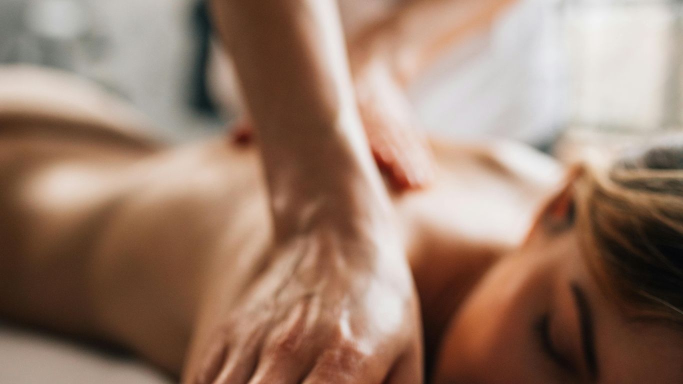 Person receiving a relaxing massage, close-up of hands, peaceful atmosphere.