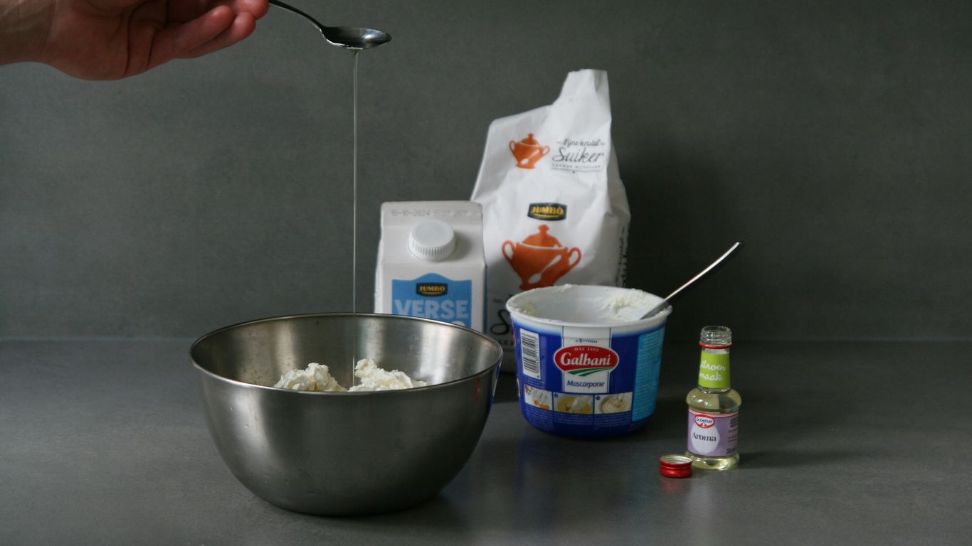 A person mixing ingredients in a bowl with a spoon