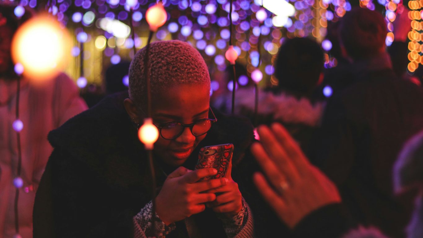 person's hand across person holding smartphone