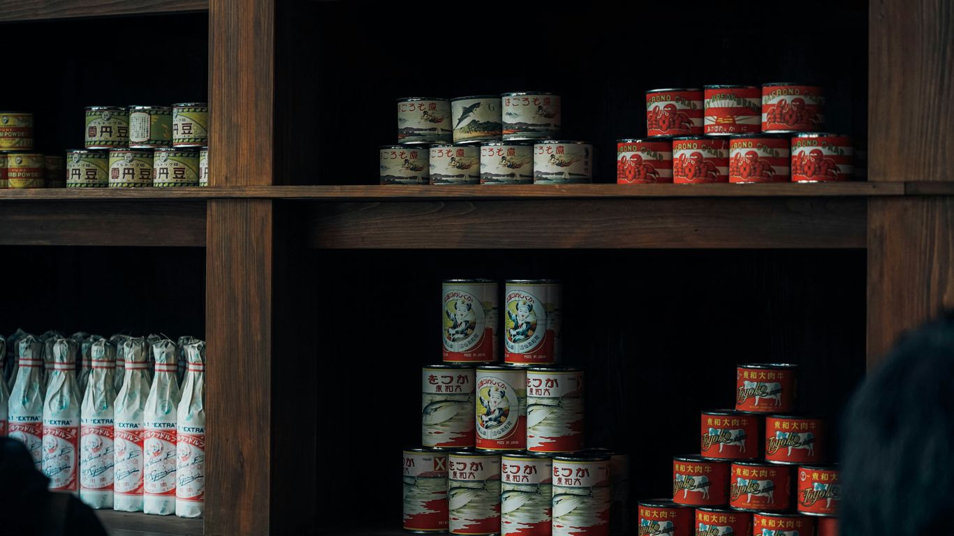 a shelf with many cans of food on it