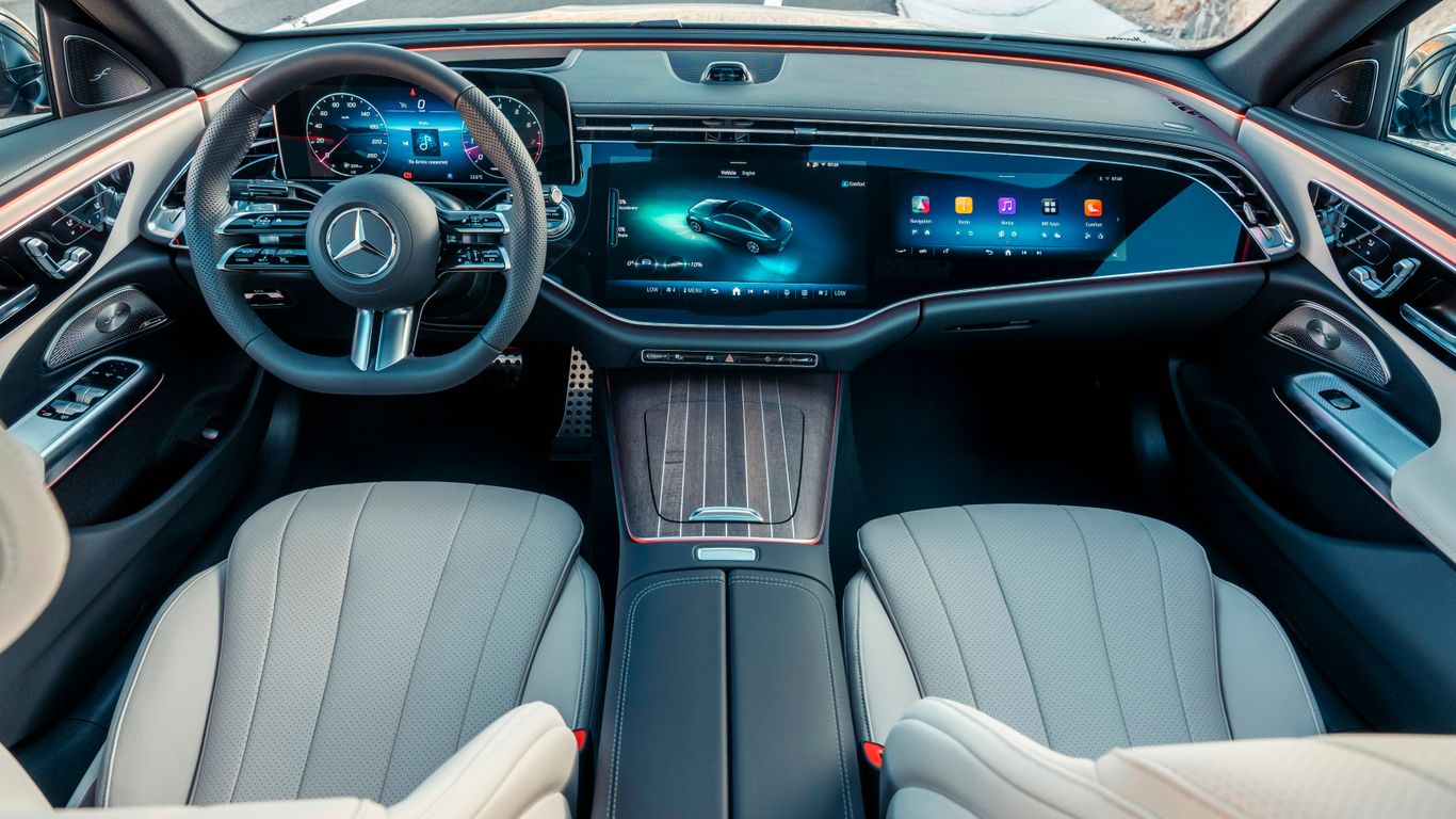 Modern car interior with large digital screens.