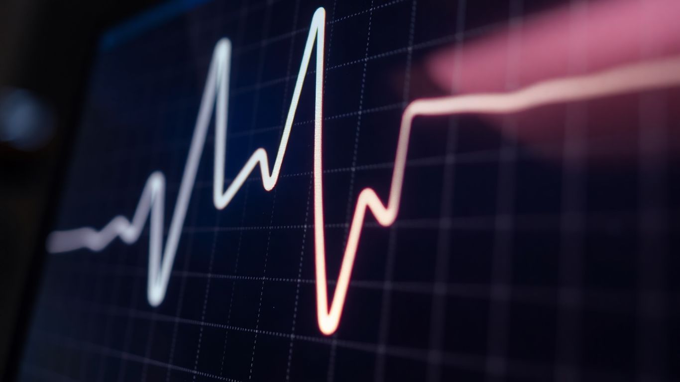 Glowing heart monitor line pulsing rhythmically.
