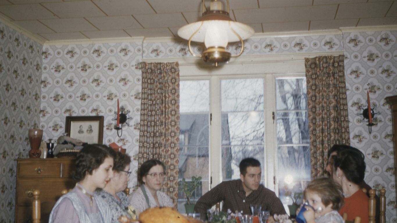 people sitting on dining chair in front of table