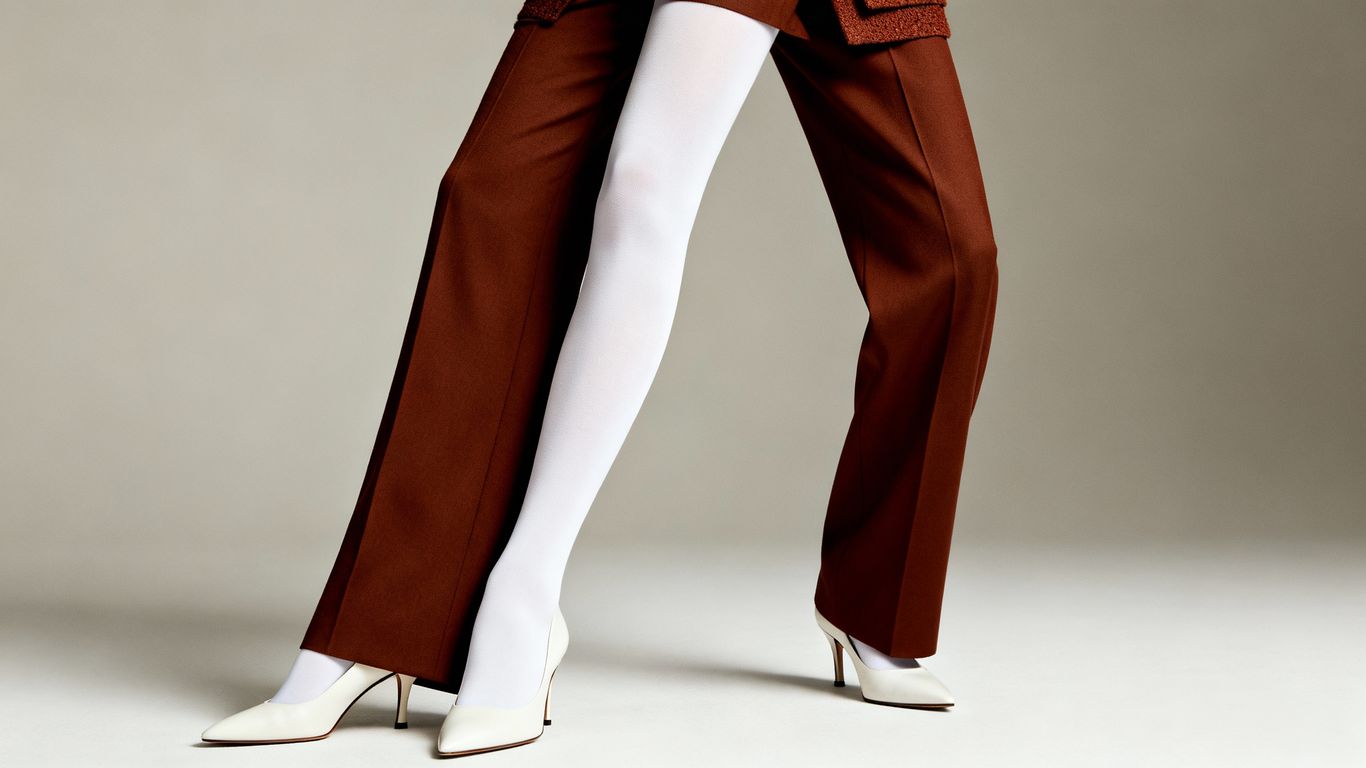 Model wearing white tights and brown trousers.