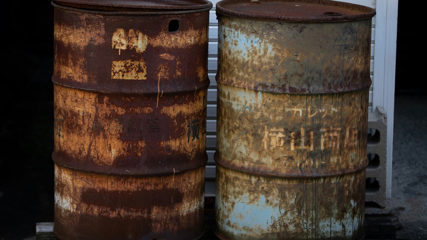 two rusty barrels sitting next to each other