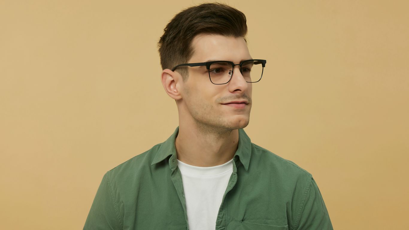 A man wearing glasses and a green shirt