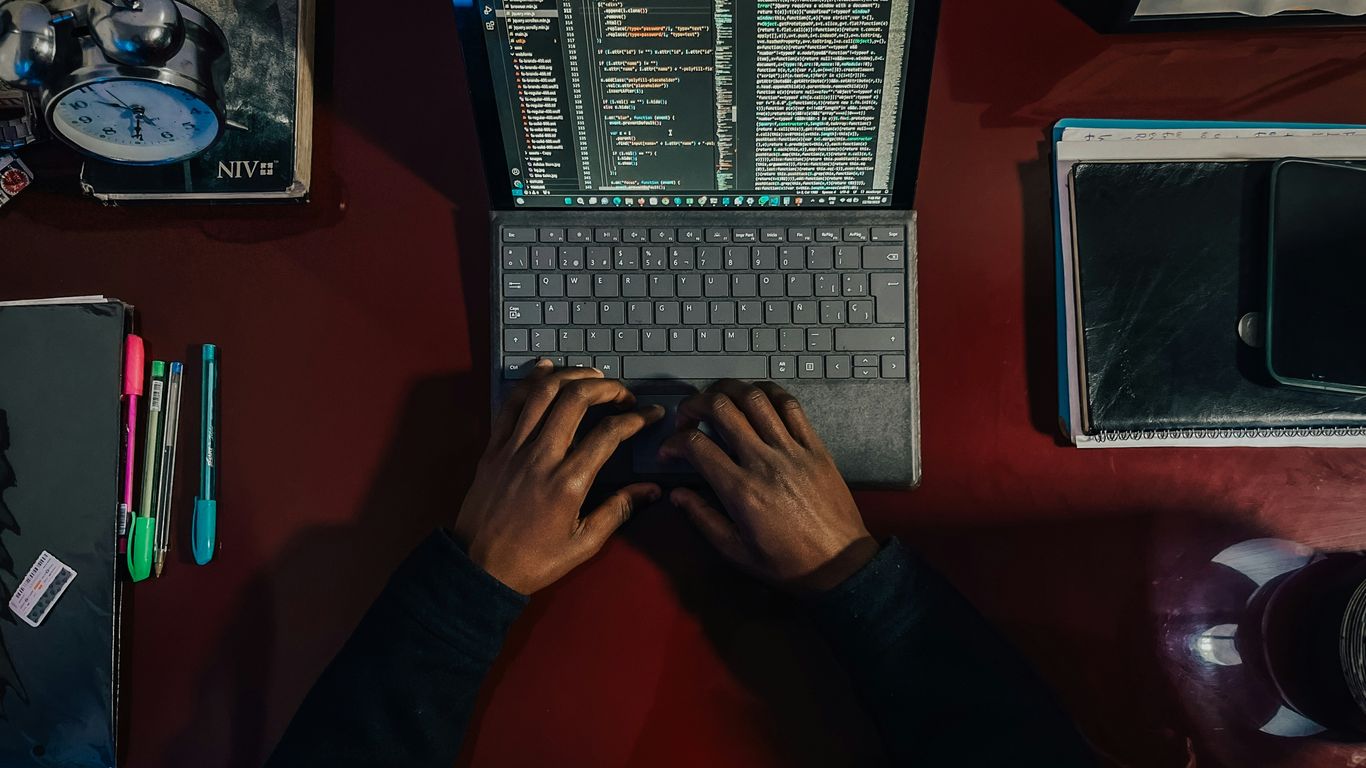 A person sitting at a desk with a laptop