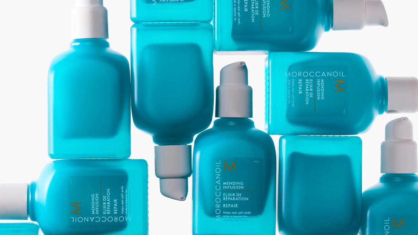 A collection of turquoise Moroccanoil hair product bottles arranged neatly.