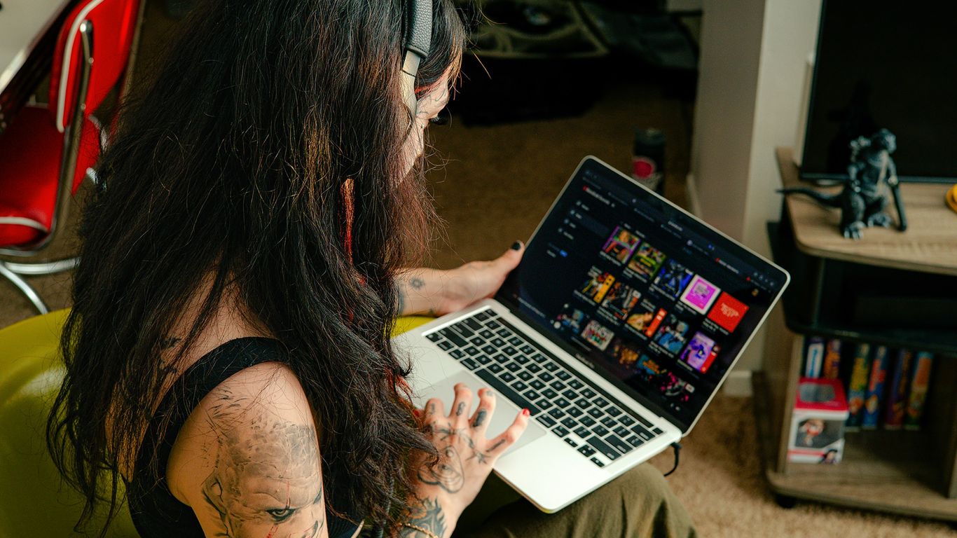 a woman sitting in a chair with a laptop