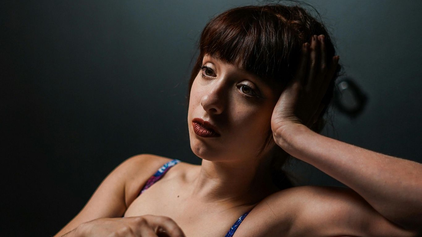 Person sitting in a bathtub, looking thoughtful and relaxed.