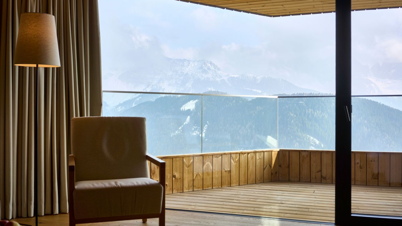 a chair sitting in a living room next to a window