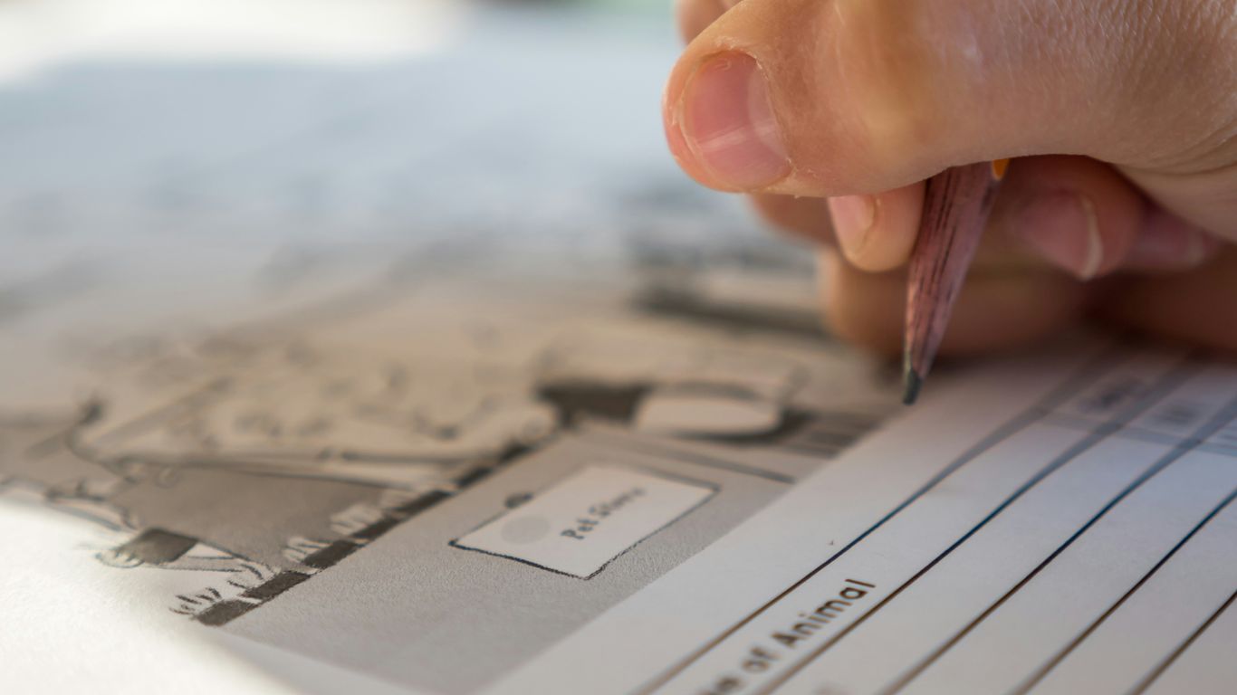 person holding pen and paper