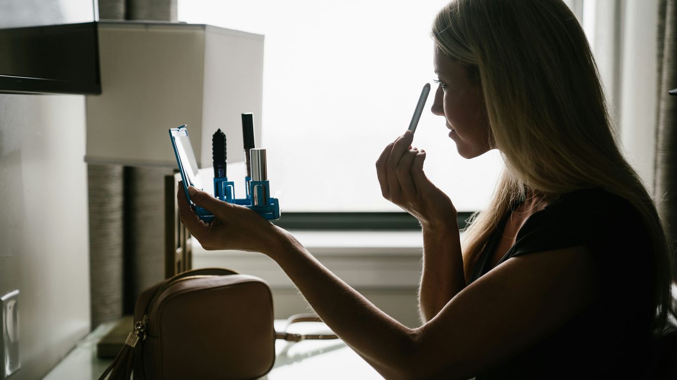 woman in black tank top holding pen
