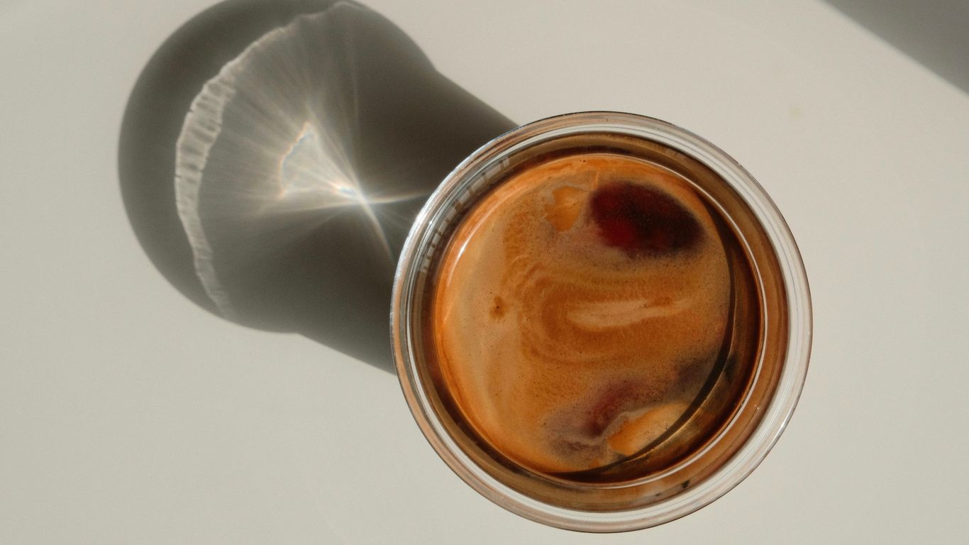 a cup of coffee sitting on top of a table
