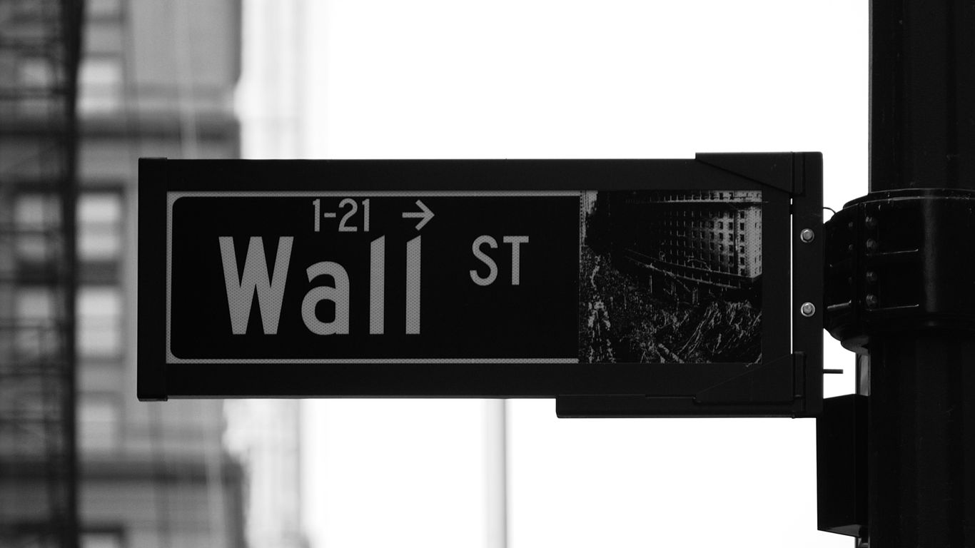 grayscale photo of Wall St. signage