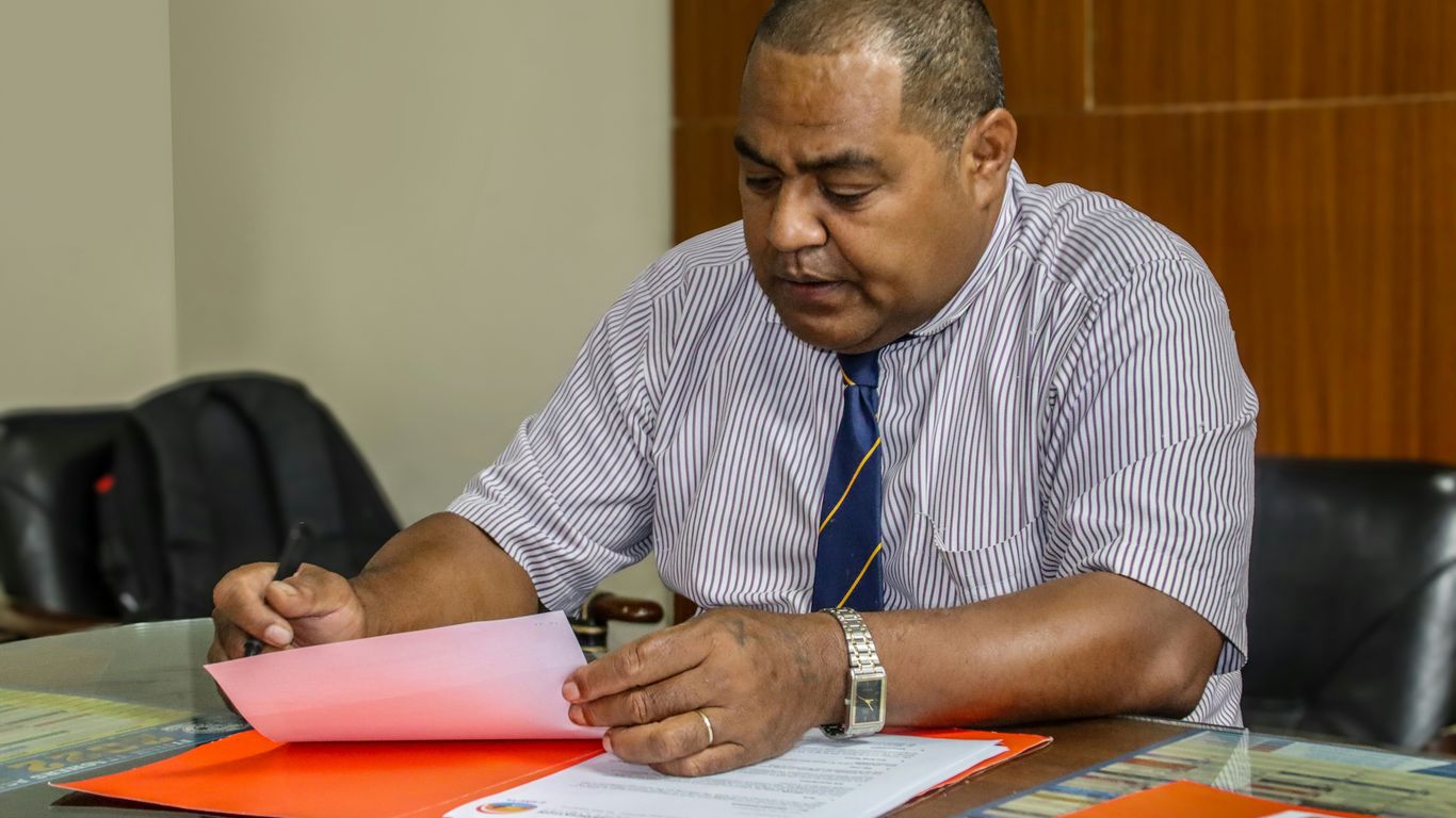 a man sitting at a table with papers in front of him