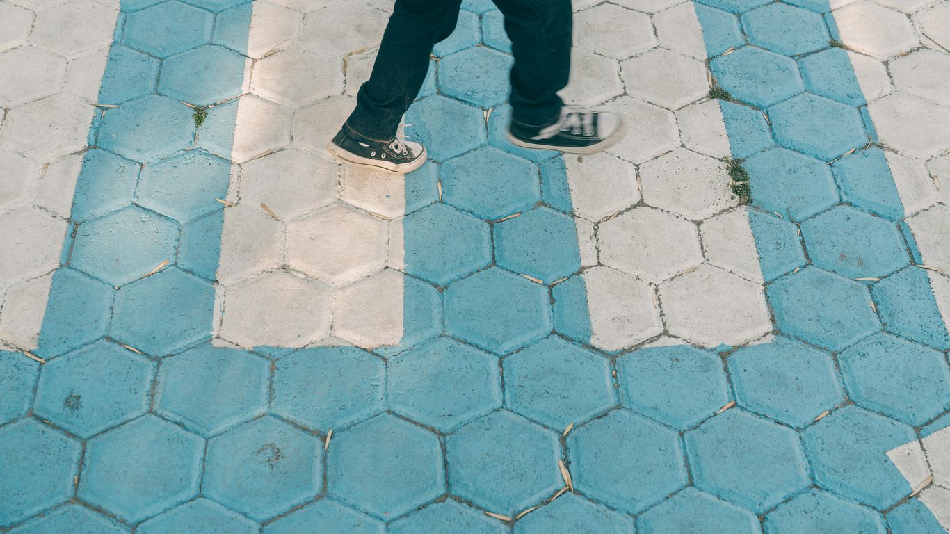 A person walking across a cross walk in a crosswalk