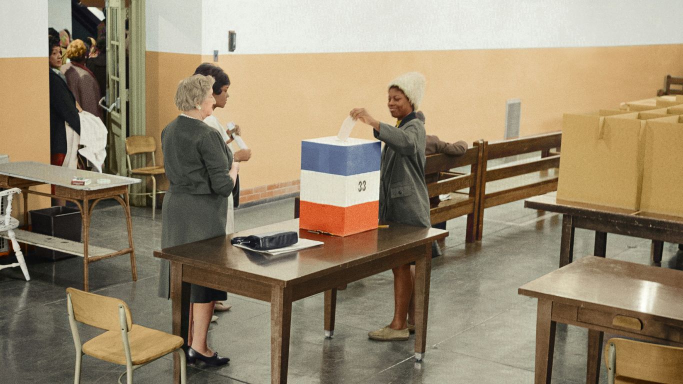 A young African American woman casting her ballot in 1964
