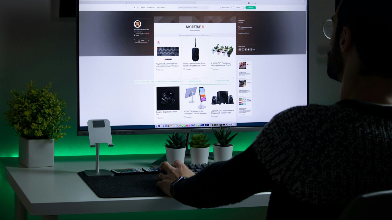 person in black sweater using computer