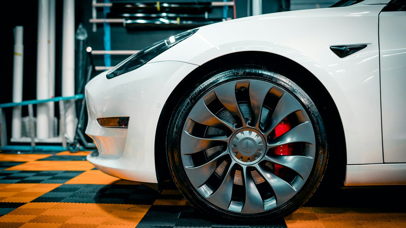 a close up of a white car on a checkered floor
