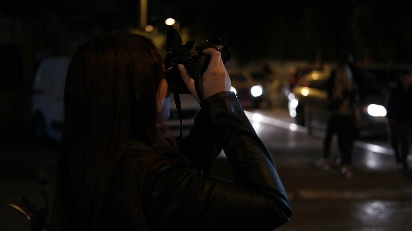 A woman taking a picture of a group of people