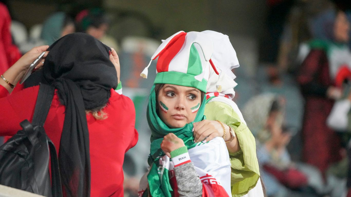 woman in flag attire by 2 person