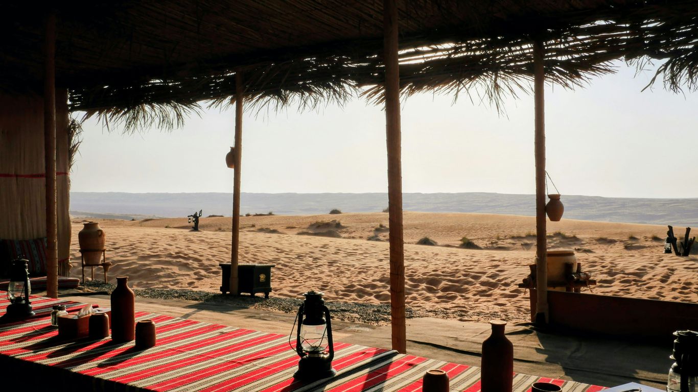 Desert oasis seating area overlooking sandy dunes