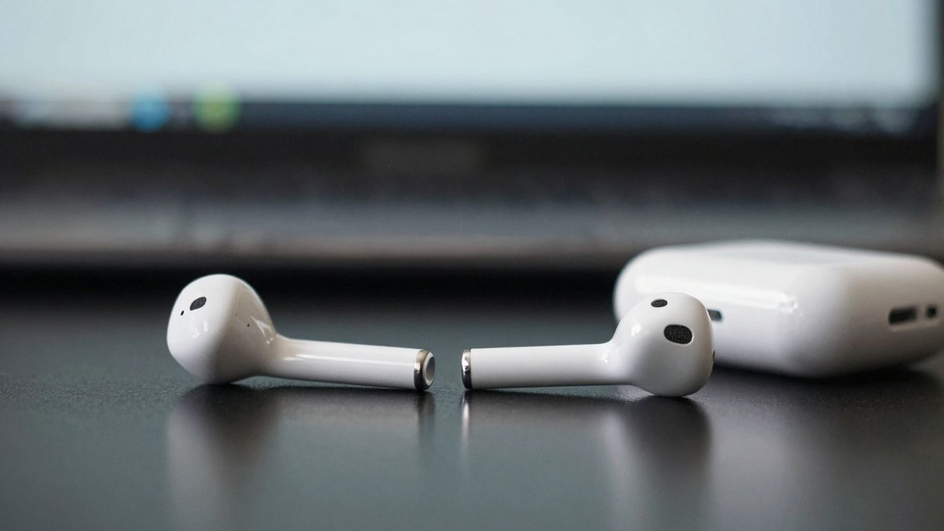 Apple AirPods on a dark surface