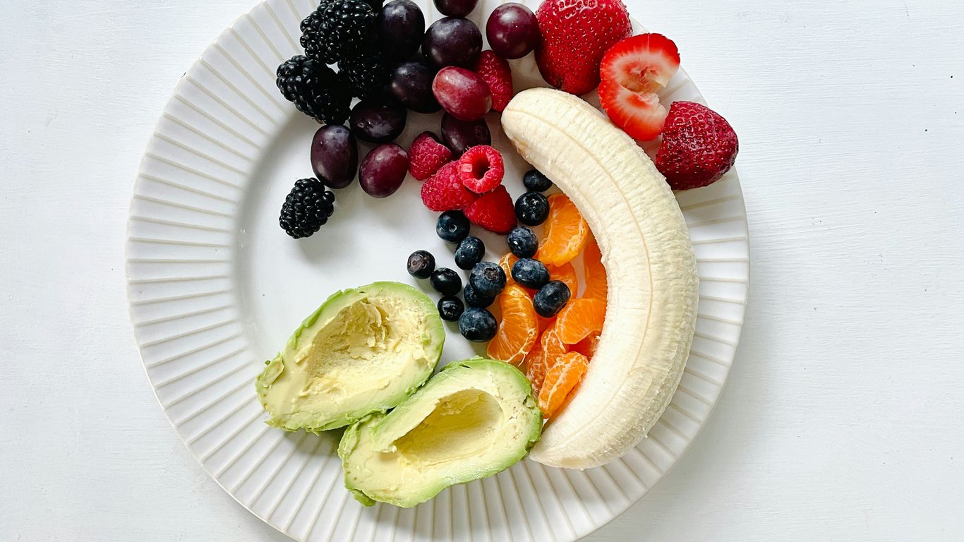 a white plate topped with fruits and vegetables