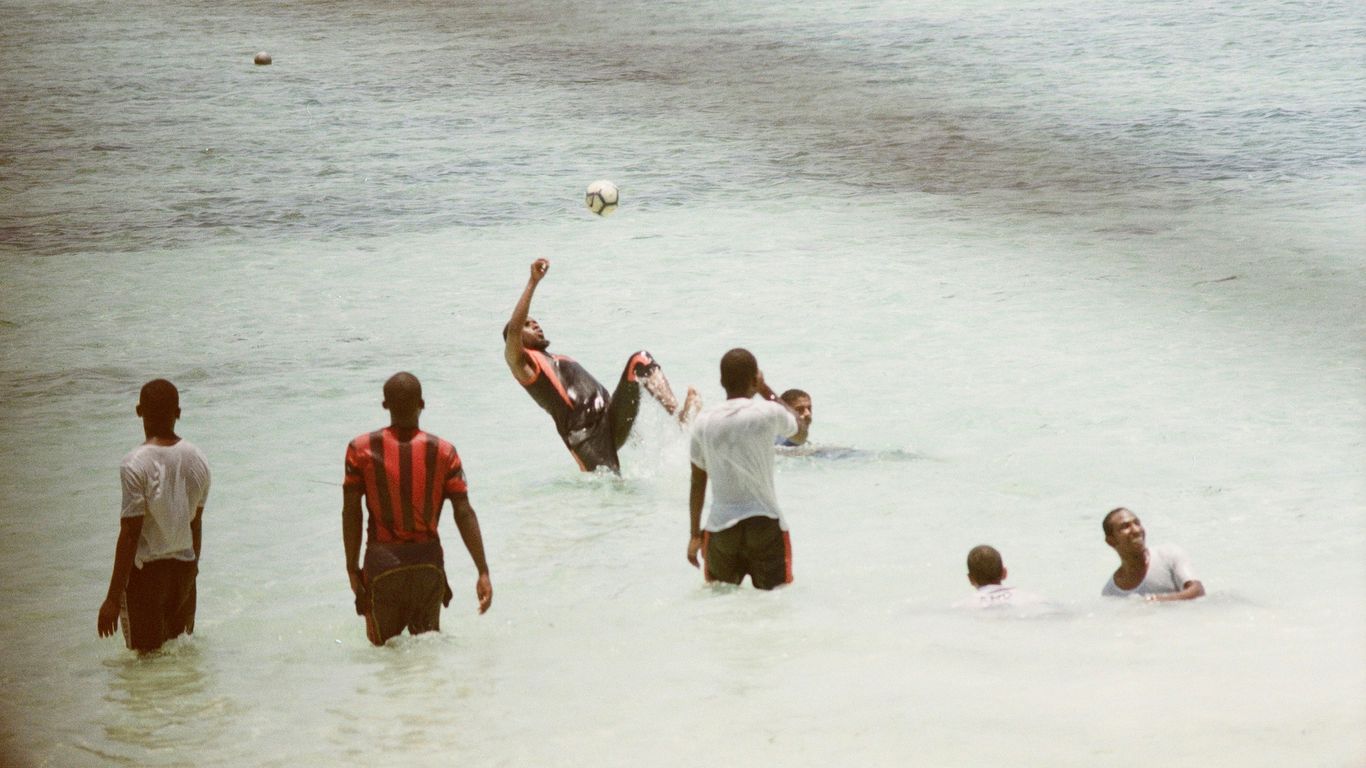 group of people playing on beach during daytime