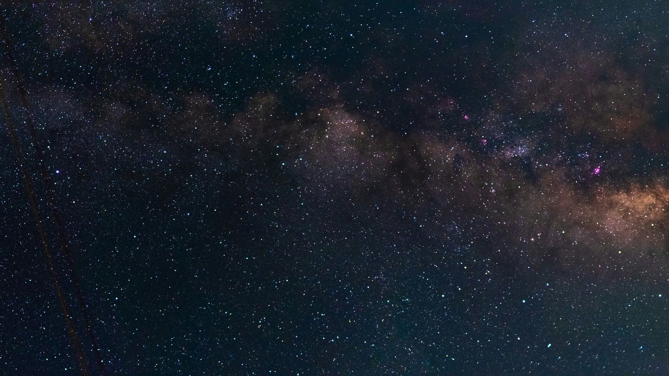 the night sky is filled with stars and clouds