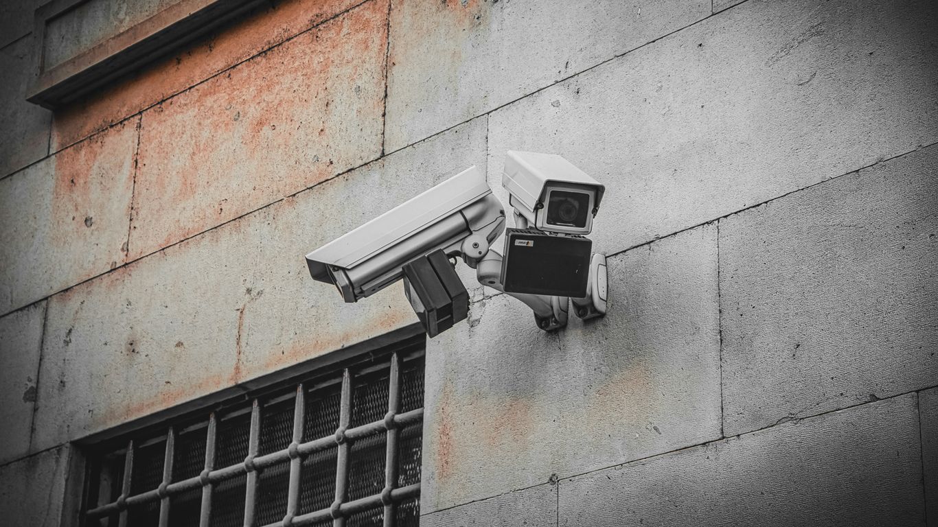 A security camera attached to the side of a building