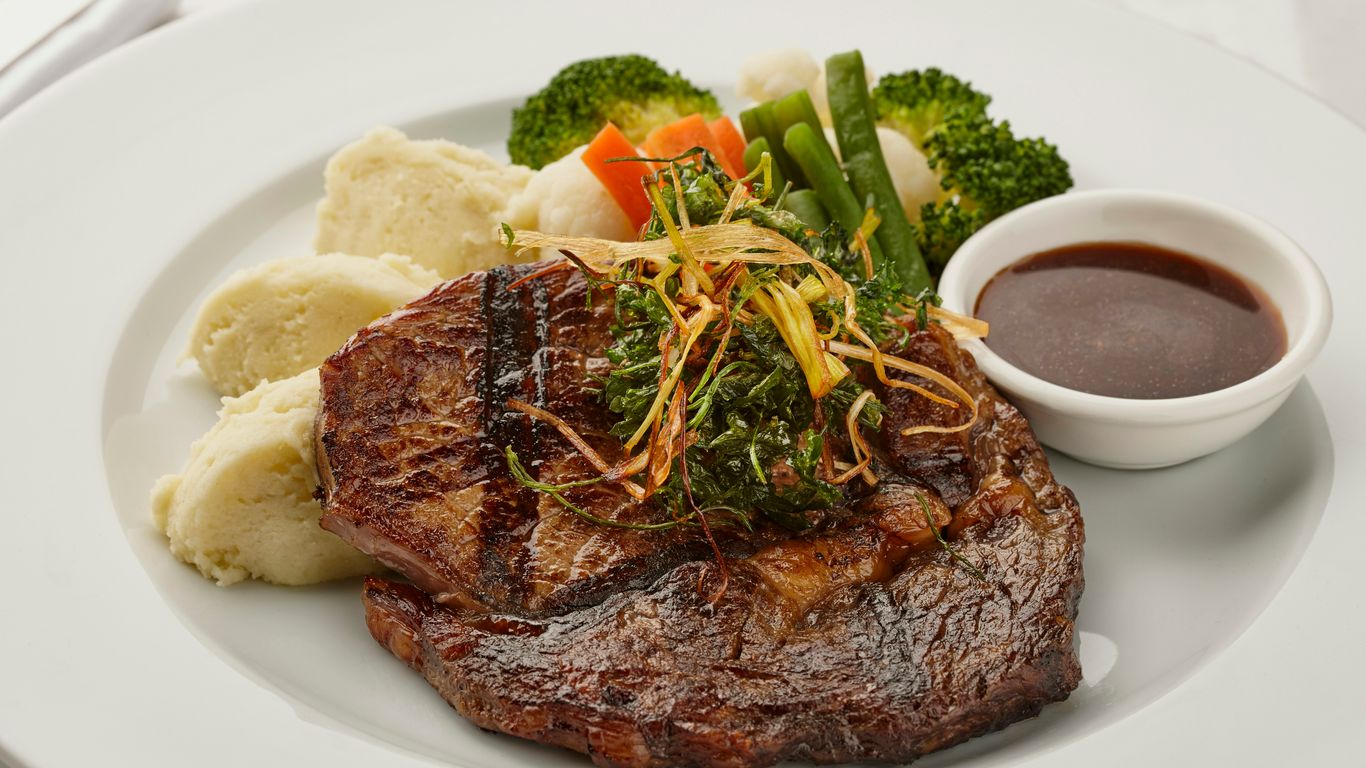 a white plate topped with steak, potatoes and broccoli