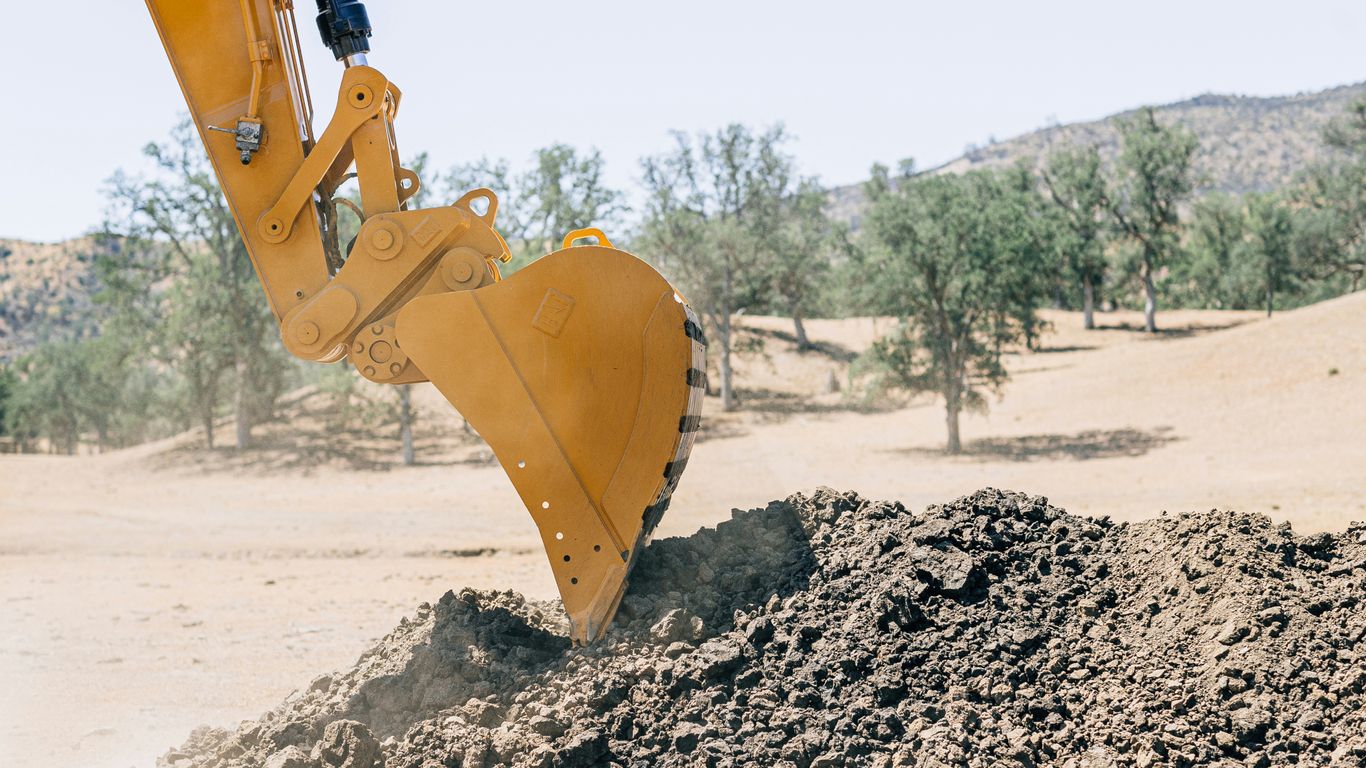 a bulldozer digging dirt in the desert