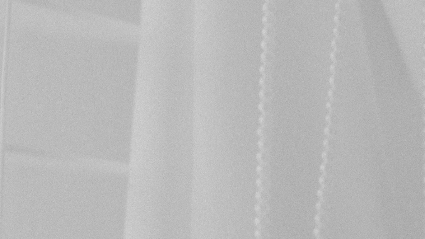 a black and white photo of a white curtain