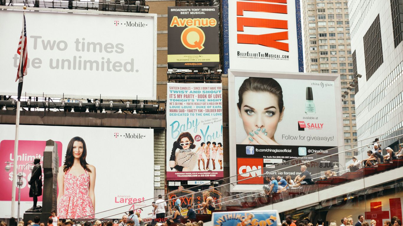 a busy city street filled with lots of billboards