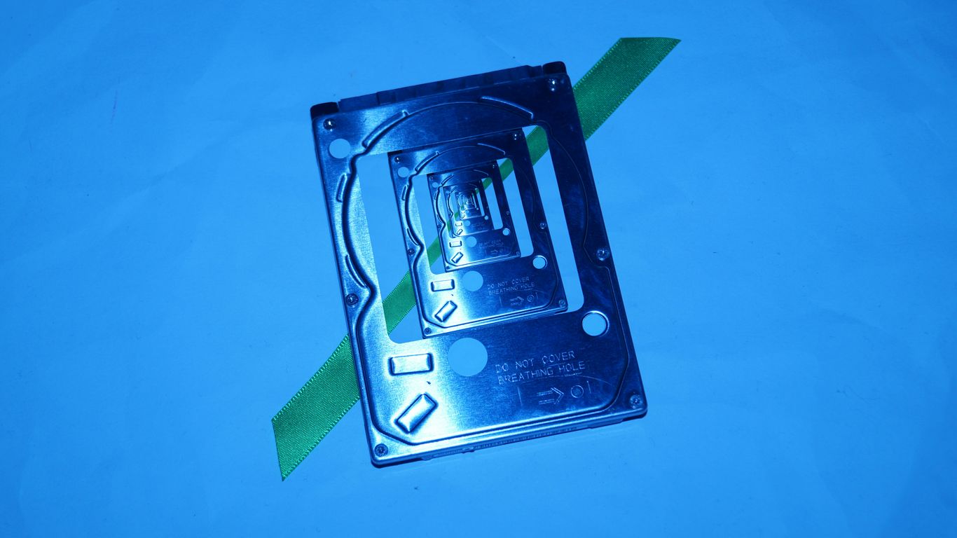 A computer hard drive with a green arrow on it