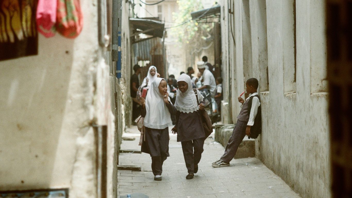 man in white dress shirt and gray pants standing beside woman in white dress