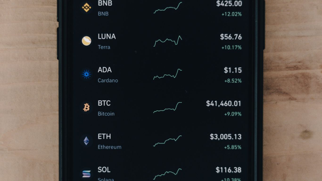 A smartphone displaying cryptocurrency market prices and trends.