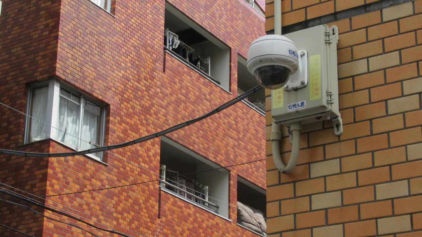 Security camera mounted on a building's exterior.