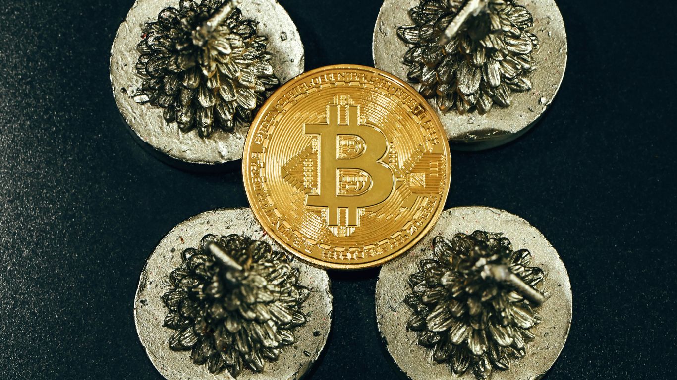 a bit coin sitting on top of some rocks